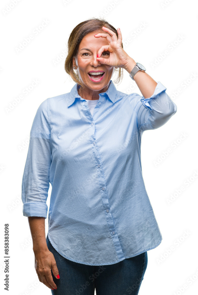 Middle age senior hispanic woman over isolated background doing ok gesture with hand smiling, eye looking through fingers with happy face. Middle age senior hispanic woman over isolated background doing ok gesture with hand smiling, eye looking through fingers with happy face.