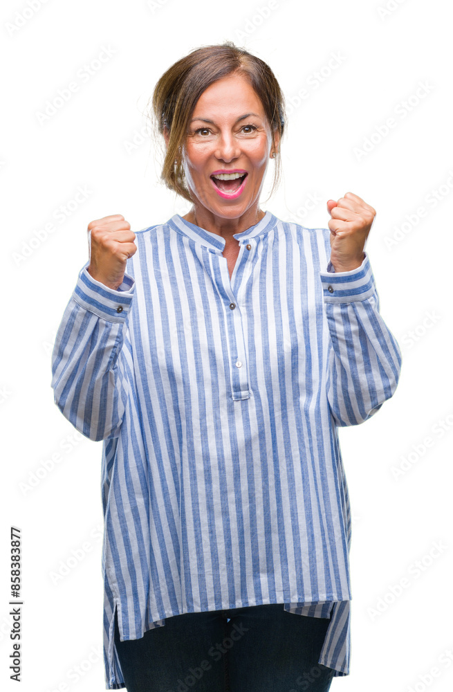Middle age senior hispanic woman over isolated background celebrating surprised and amazed for success with arms raised and open eyes. Winner concept. Middle age senior hispanic woman over isolated background celebrating surprised and amazed for success with arms raised and open eyes. Winner concept.