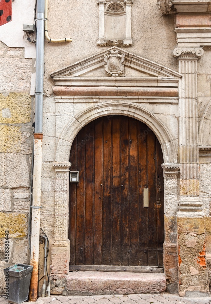 Old wooden door in a stoned ancient frame