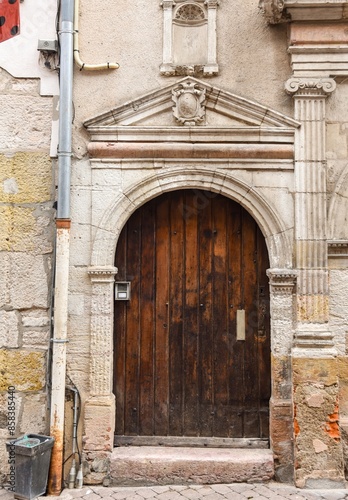 Old wooden door in a stoned ancient frame