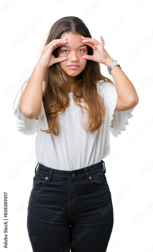 Young beautiful brunette business woman over isolated background Trying to open eyes with fingers, sleepy and tired for morning fatigue Young beautiful brunette business woman over isolated background Trying to open eyes with fingers, sleepy and tired for morning fatigue