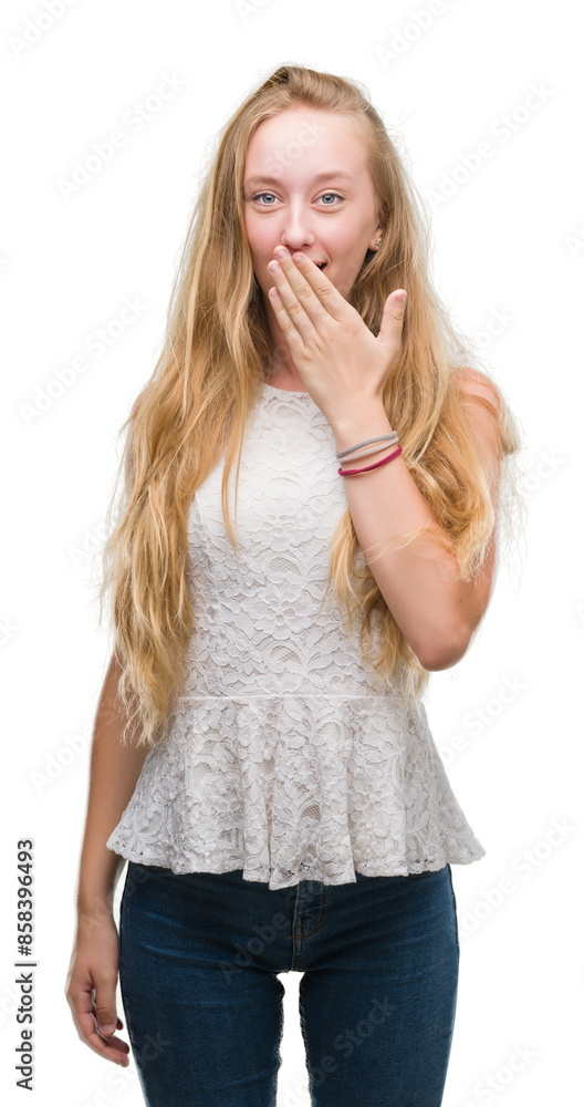 Blonde teenager woman cover mouth with hand shocked with shame for mistake, expression of fear, scared in silence, secret concept Blonde teenager woman cover mouth with hand shocked with shame for mistake, expression of fear, scared in silence, secret concept