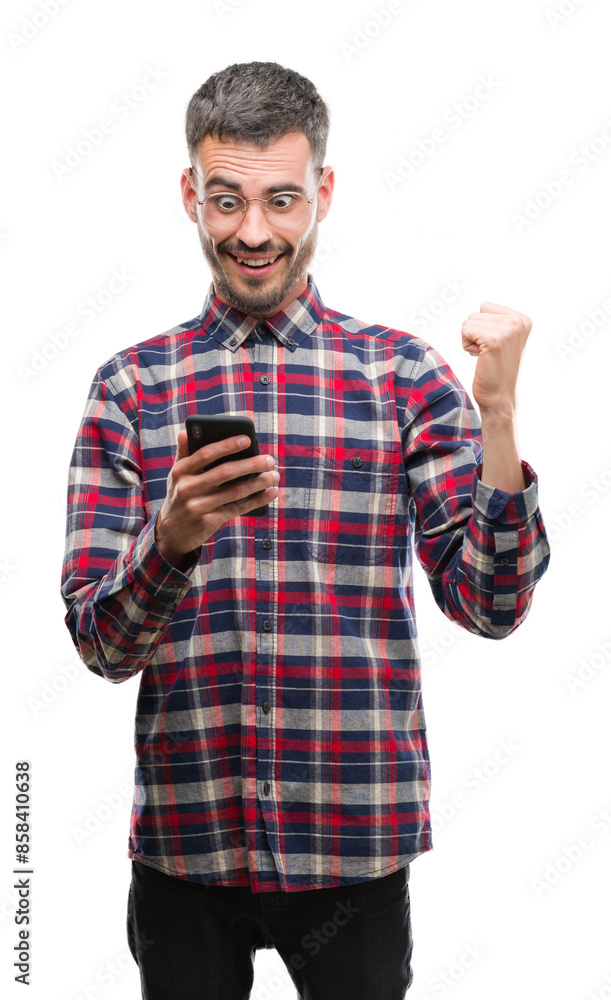 Young hipster adult man holding smartphone screaming proud and celebrating victory and success very excited, cheering emotion Young hipster adult man holding smartphone screaming proud and celebrating victory and success very excited, cheering emotion