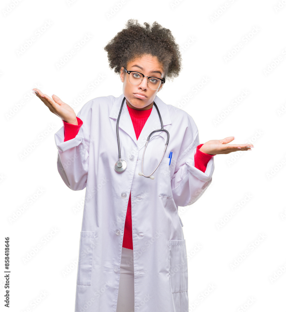Young afro american doctor woman over isolated background clueless and confused expression with arms and hands raised. Doubt concept. Young afro american doctor woman over isolated background clueless and confused expression with arms and hands raised. Doubt concept.