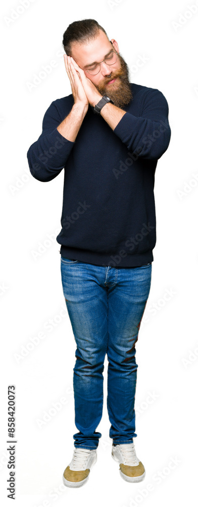 Young blond man wearing glasses and turtleneck sweater sleeping tired dreaming and posing with hands together while smiling with closed eyes. Young blond man wearing glasses and turtleneck sweater sleeping tired dreaming and posing with hands together while smiling with closed eyes.