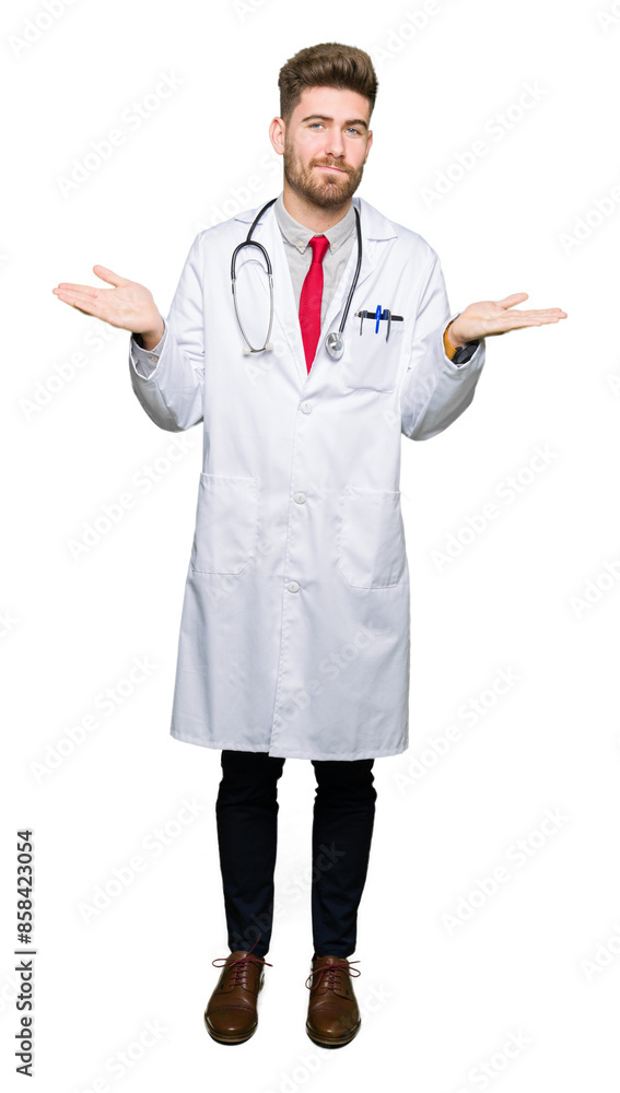 Young handsome doctor man wearing medical coat clueless and confused expression with arms and hands raised. Doubt concept. Young handsome doctor man wearing medical coat clueless and confused expression with arms and hands raised. Doubt concept.