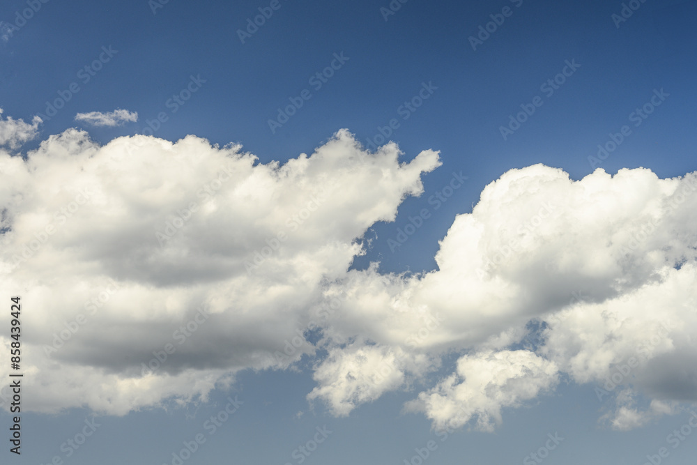 Obraz premium Fluffy White Clouds Against a Blue Sky