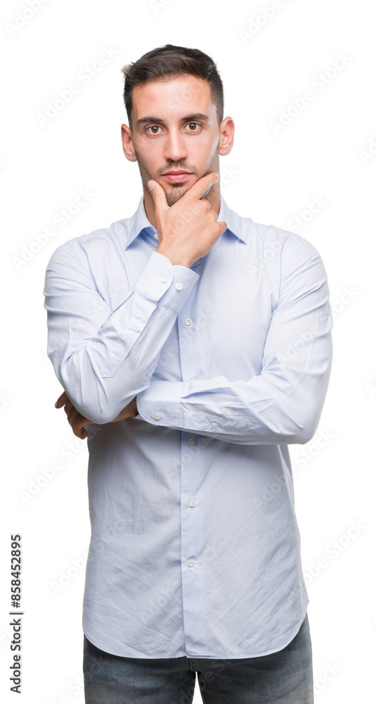 Handsome young businessman looking confident at the camera with smile with crossed arms and hand raised on chin. Thinking positive. Handsome young businessman looking confident at the camera with smile with crossed arms and hand raised on chin. Thinking positive.