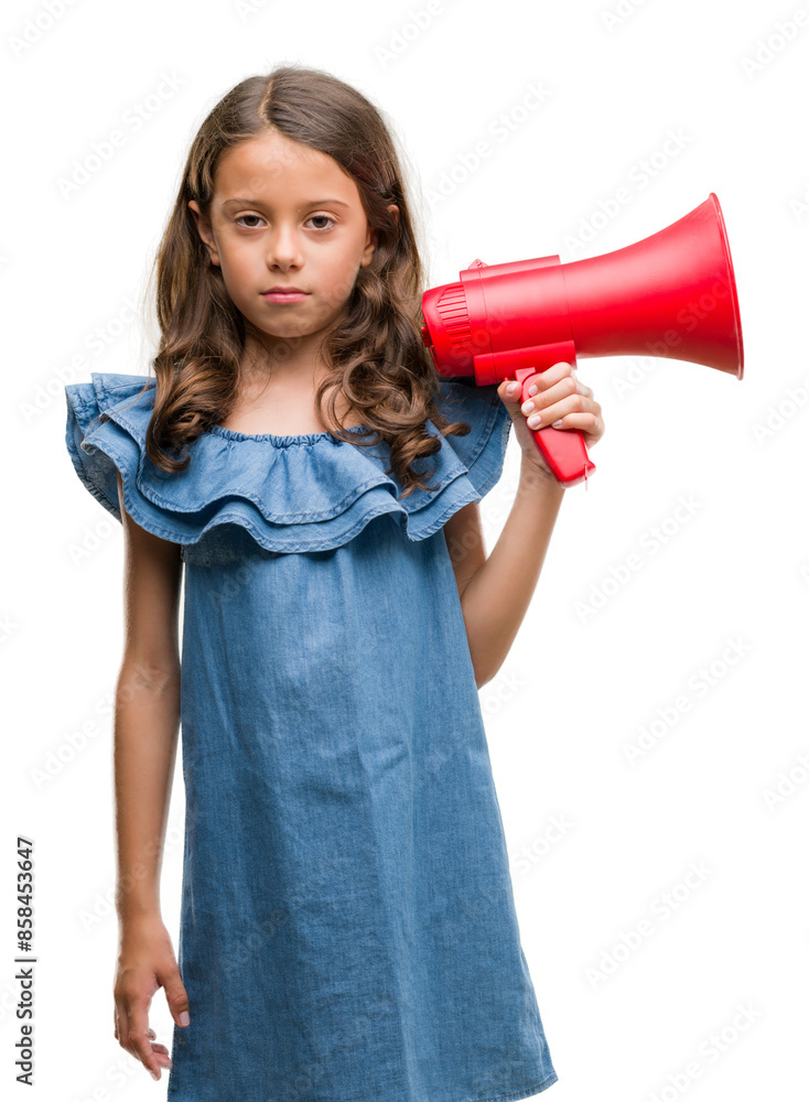 Brunette hispanic girl holding red megaphone with a confident expression on smart face thinking serious Brunette hispanic girl holding red megaphone with a confident expression on smart face thinking serious