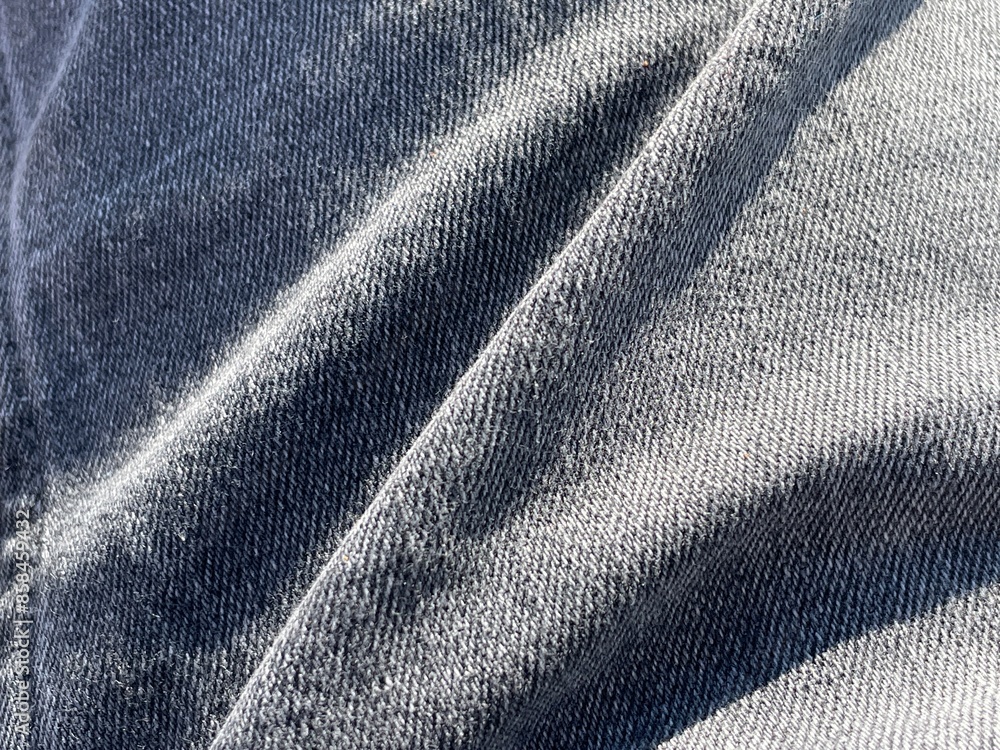 Close-up of grey jeans clothing, showing folds in material Close-up of grey jeans clothing, showing folds in material