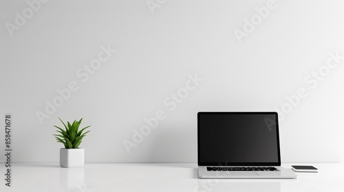 Wallpaper Mural A minimalist workspace with a clean, white desk, a single laptop, and a small potted plant Torontodigital.ca