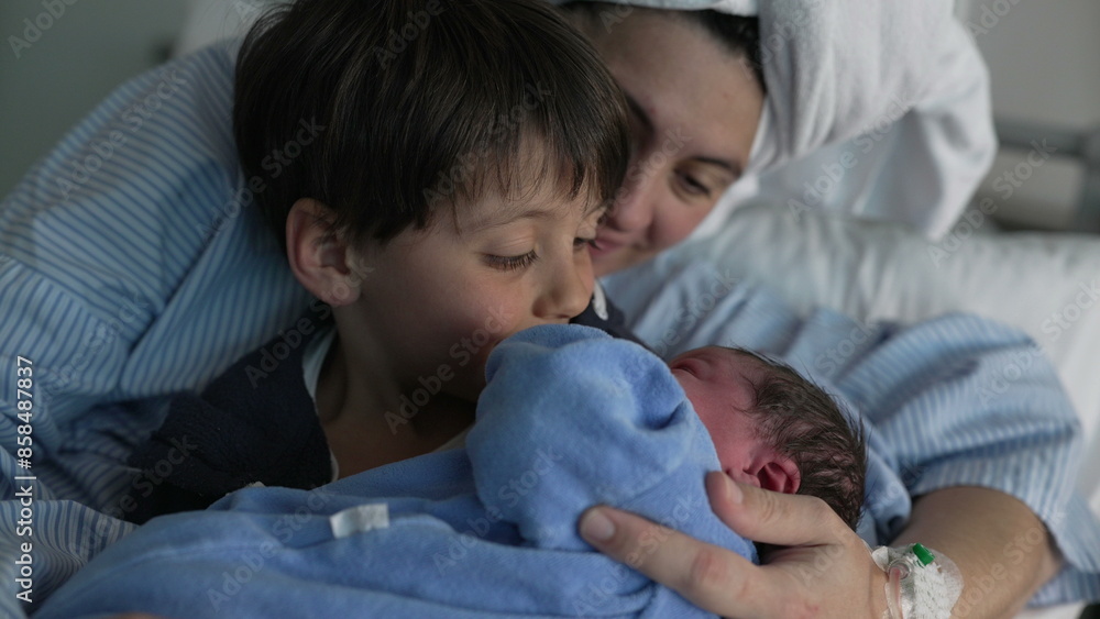 Family Welcomes Newborn at Hospital - Brother Holds Baby as Mother Looks On, Celebrating First Sibling Bonding Family Welcomes Newborn at Hospital - Brother Holds Baby as Mother Looks On, Celebrating First Sibling Bonding