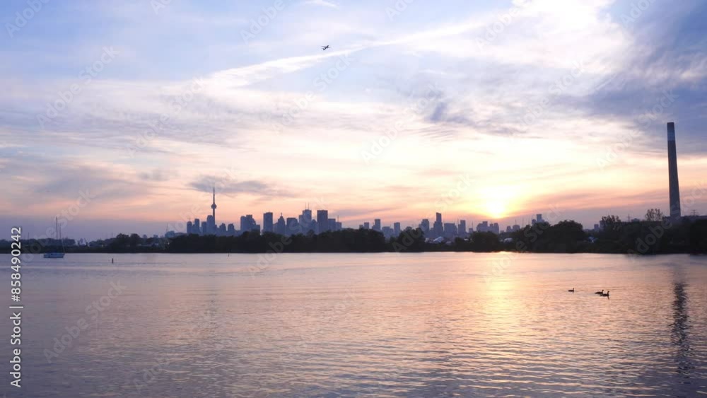 Toronto skyline with birds, plane and boat, view from Tommy Thompson Park at sunset Toronto skyline with birds, plane and boat, view from Tommy Thompson Park at sunset