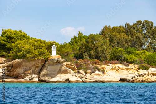 Scenic view of Diaporos Island shore with beautiful rocks and a shrine, Singitic Gulf, Chalkidiki, Northern Greece, Aegean Sea photo