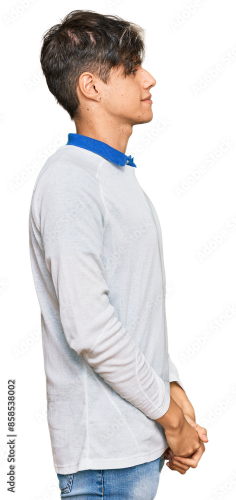 Young hispanic man wearing casual clothes looking to side, relax profile pose with natural face with confident smile. Young hispanic man wearing casual clothes looking to side, relax profile pose with natural face with confident smile.