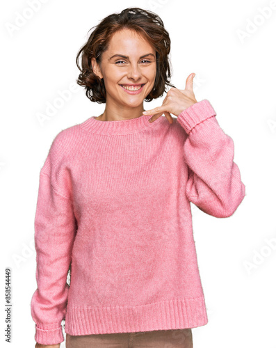 Young hispanic woman wearing casual clothes smiling doing phone gesture with hand and fingers like talking on the telephone. communicating concepts.