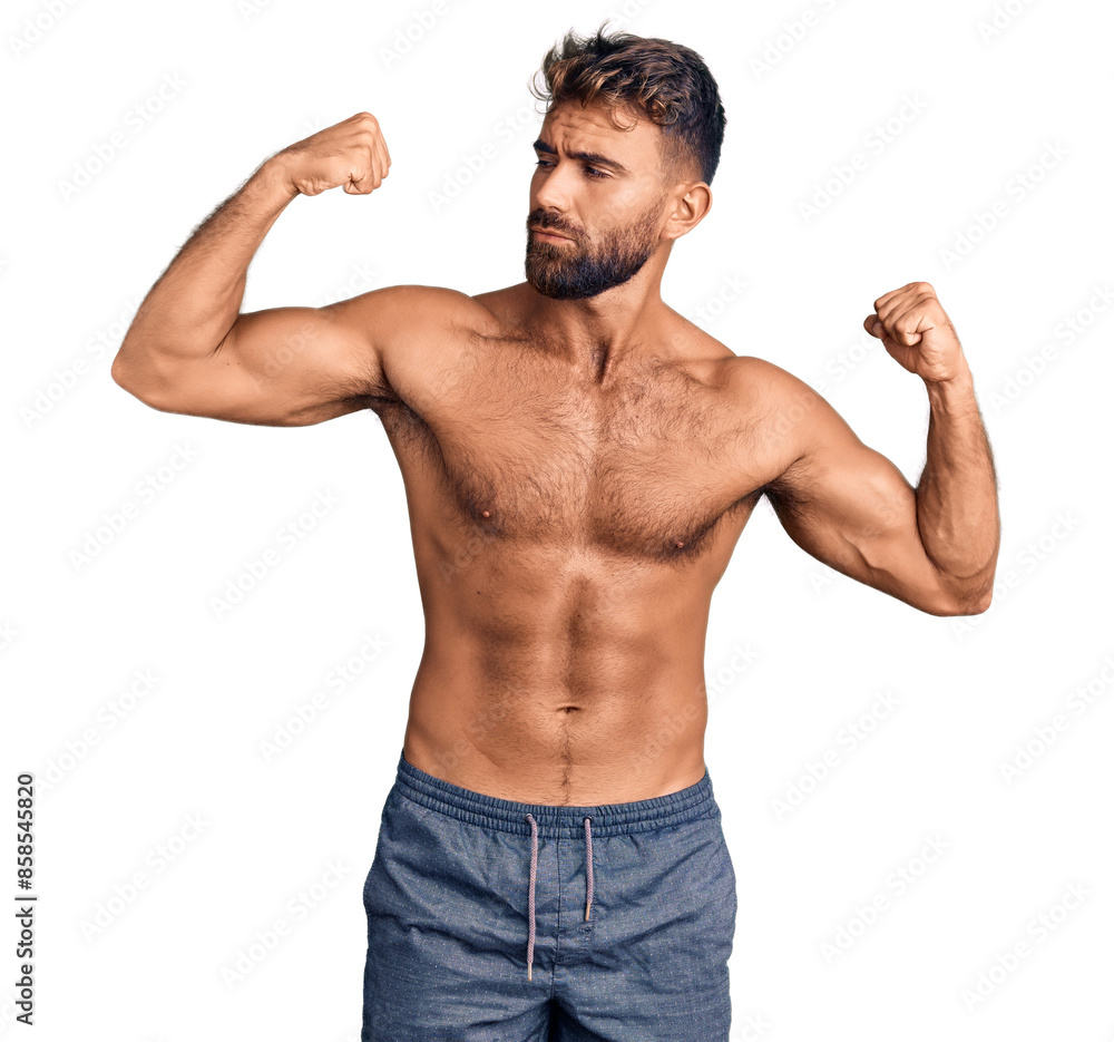 Young hispanic man wearing swimwear shirtless showing arms muscles smiling proud. fitness concept. Young hispanic man wearing swimwear shirtless showing arms muscles smiling proud. fitness concept.
