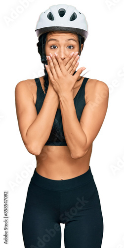 Beautiful hispanic woman wearing bike helmet shocked covering mouth with hands for mistake. secret concept. © Krakenimages.com