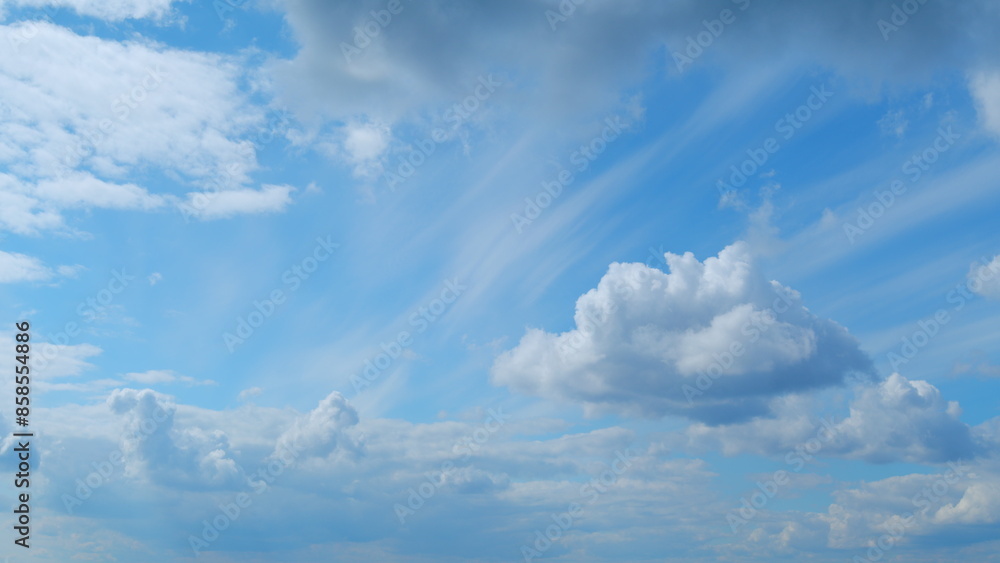 Fototapeta premium Clouds move in the blue sky. Tropical sky at day time, only white and blue colors. Semi-transparent layers on different height. Time lapse.