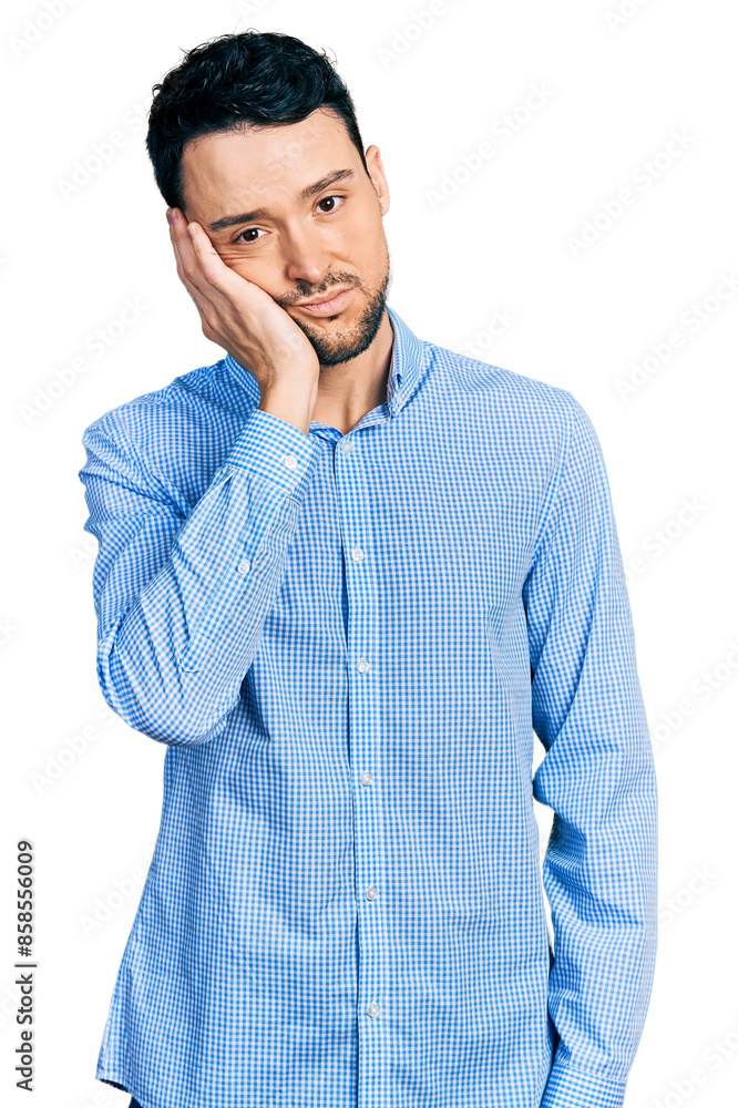 Hispanic man with beard wearing casual business shirt thinking looking tired and bored with depression problems with crossed arms. Hispanic man with beard wearing casual business shirt thinking looking tired and bored with depression problems with crossed arms.