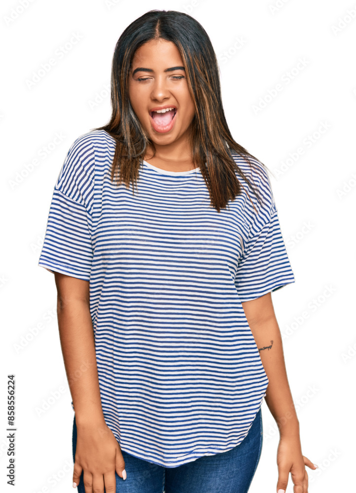 Young latin girl wearing casual clothes winking looking at the camera with sexy expression, cheerful and happy face. Young latin girl wearing casual clothes winking looking at the camera with sexy expression, cheerful and happy face.