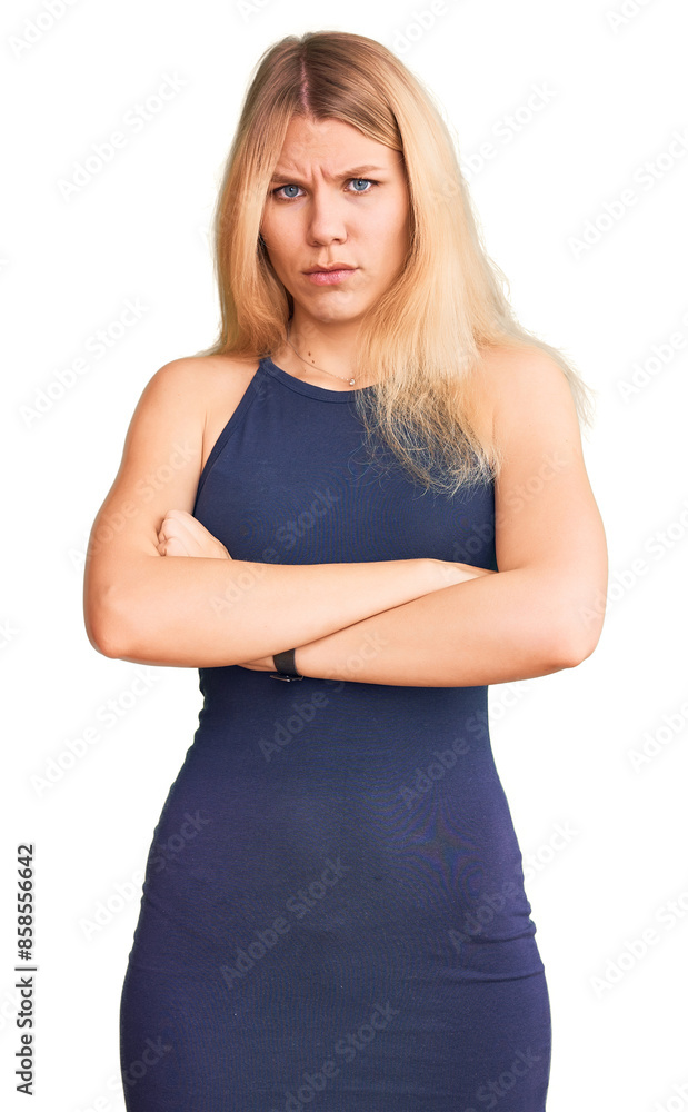 Fototapeta premium Young beautiful blonde woman wearing casual dress skeptic and nervous, disapproving expression on face with crossed arms. negative person.