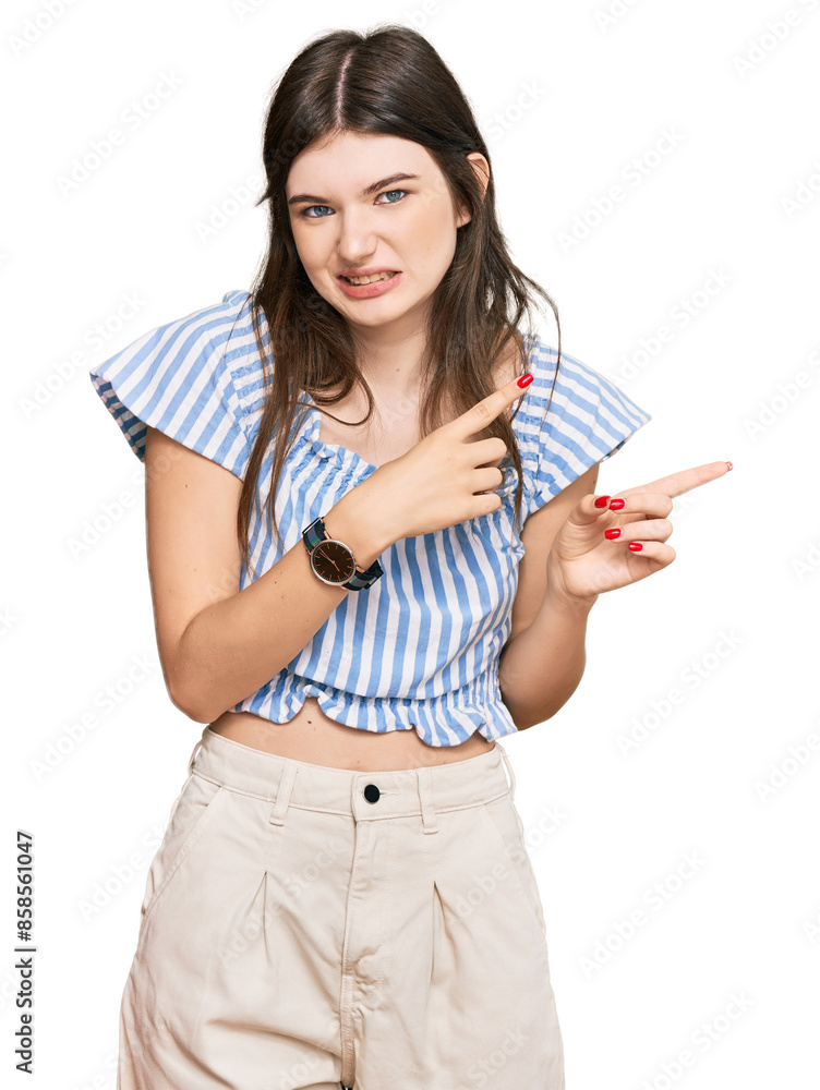 Young beautiful caucasian girl wearing casual clothes pointing aside worried and nervous with both hands, concerned and surprised expression Young beautiful caucasian girl wearing casual clothes pointing aside worried and nervous with both hands, concerned and surprised expression
