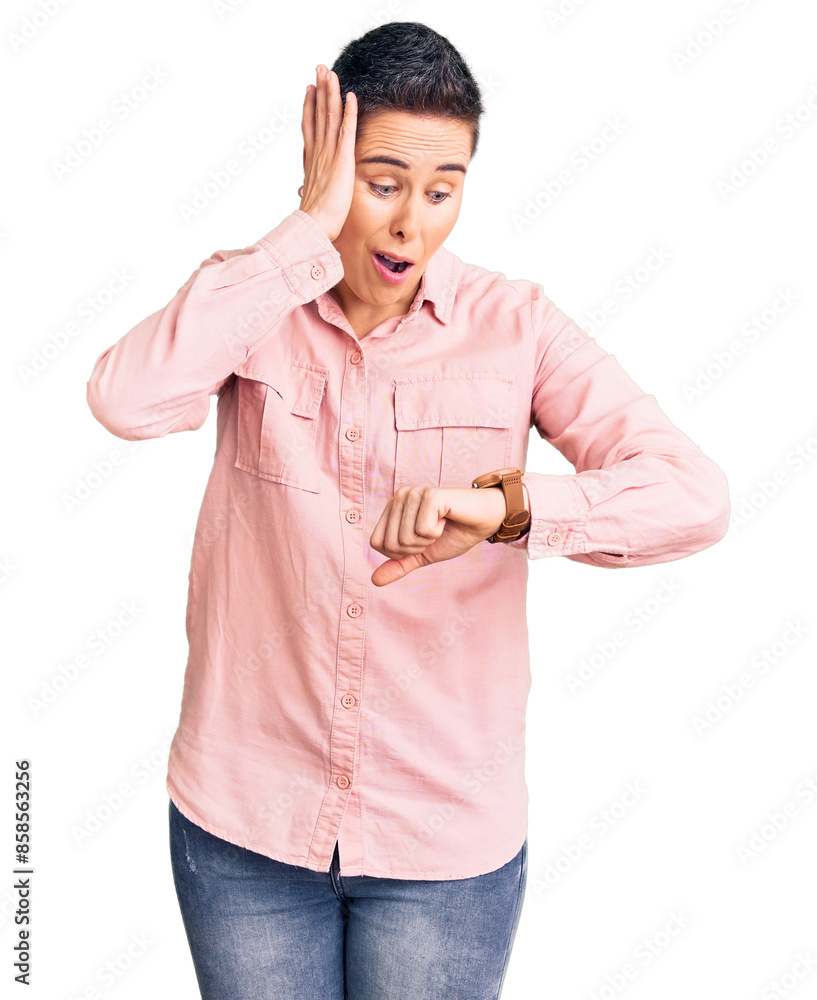 Young woman with short hair wearing casual clothes looking at the watch time worried, afraid of getting late Young woman with short hair wearing casual clothes looking at the watch time worried, afraid of getting late