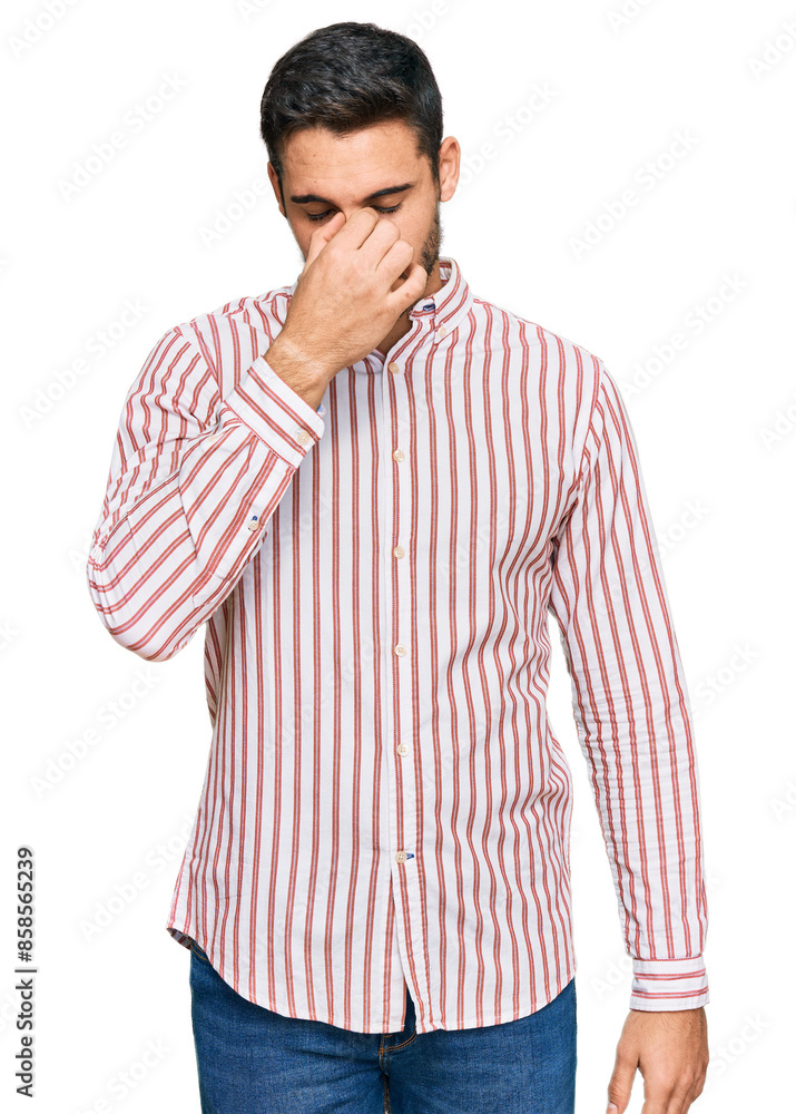 Young hispanic man wearing business shirt tired rubbing nose and eyes feeling fatigue and headache. stress and frustration concept. Young hispanic man wearing business shirt tired rubbing nose and eyes feeling fatigue and headache. stress and frustration concept.