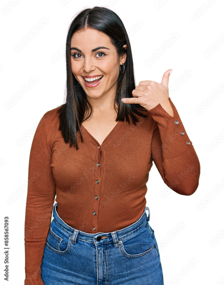Young hispanic woman wearing casual clothes smiling doing phone gesture with hand and fingers like talking on the telephone. communicating concepts. Young hispanic woman wearing casual clothes smiling doing phone gesture with hand and fingers like talking on the telephone. communicating concepts.