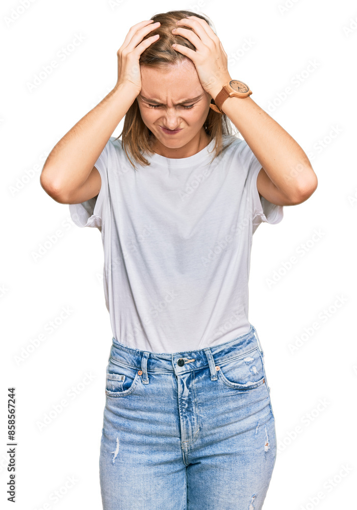 Beautiful young blonde woman wearing casual white t shirt suffering from headache desperate and stressed because pain and migraine. hands on head. Beautiful young blonde woman wearing casual white t shirt suffering from headache desperate and stressed because pain and migraine. hands on head.