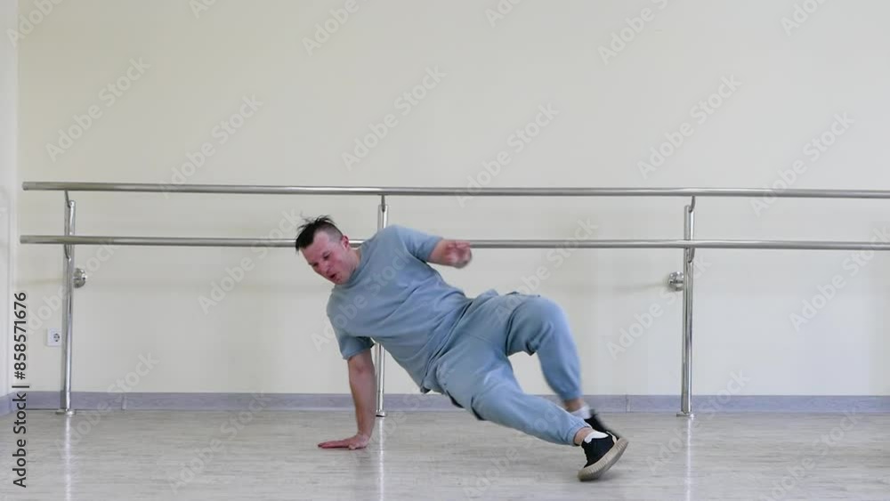 Training a modern break dancer with a trick. A young dancer in the studio practices modern dancing. Active lifestyle, active lifestyle concept. Training a modern break dancer with a trick. A young dancer in the studio practices modern dancing. Active lifestyle, active lifestyle concept.