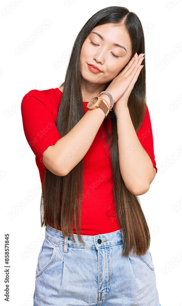 Young chinese woman wearing casual clothes sleeping tired dreaming and posing with hands together while smiling with closed eyes. Young chinese woman wearing casual clothes sleeping tired dreaming and posing with hands together while smiling with closed eyes.