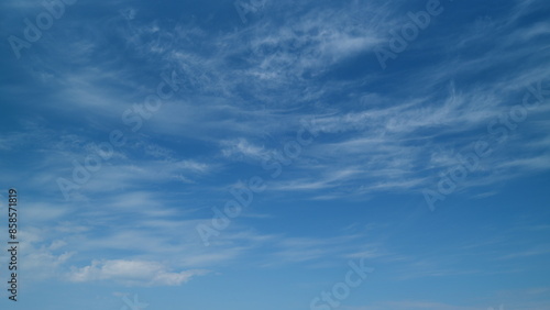 Blue sky with white cirrus clouds. Sunny background, blue sky with white cirrus clouds. Timelapse. © artifex.orlova