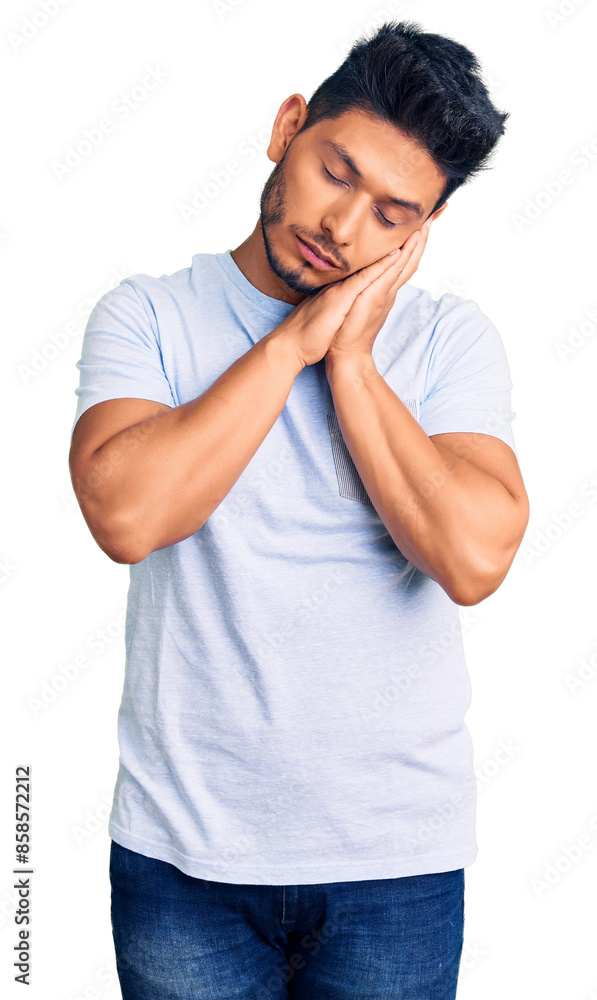 Handsome latin american young man wearing casual clothes sleeping tired dreaming and posing with hands together while smiling with closed eyes. Handsome latin american young man wearing casual clothes sleeping tired dreaming and posing with hands together while smiling with closed eyes.