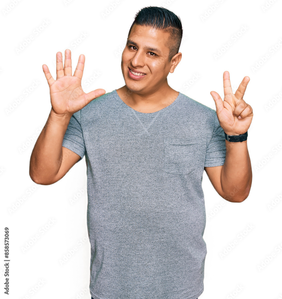 Young latin man wearing casual clothes showing and pointing up with fingers number eight while smiling confident and happy. Young latin man wearing casual clothes showing and pointing up with fingers number eight while smiling confident and happy.