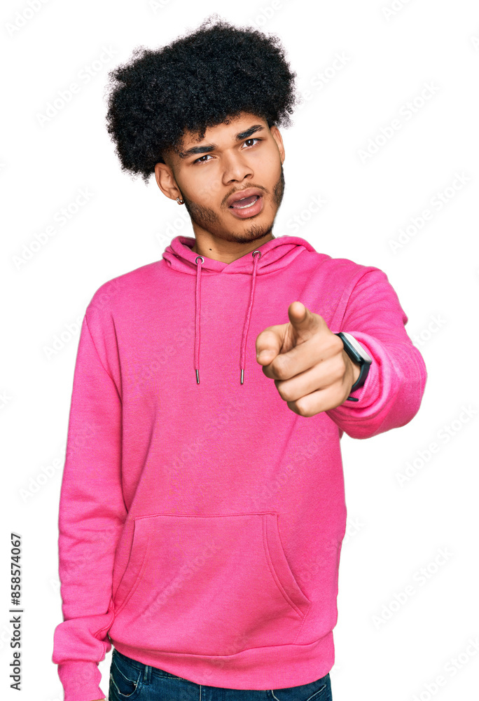 Young african american man with afro hair wearing casual pink sweatshirt pointing displeased and frustrated to the camera, angry and furious with you Young african american man with afro hair wearing casual pink sweatshirt pointing displeased and frustrated to the camera, angry and furious with you