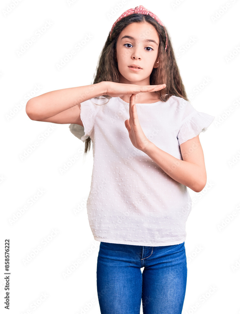 Cute hispanic child girl wearing casual white tshirt doing time out gesture with hands, frustrated and serious face Cute hispanic child girl wearing casual white tshirt doing time out gesture with hands, frustrated and serious face