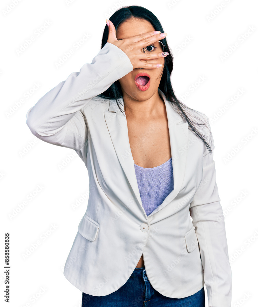 Beautiful hispanic woman with nose piercing wearing business jacket and glasses peeking in shock covering face and eyes with hand, looking through fingers with embarrassed expression. Beautiful hispanic woman with nose piercing wearing business jacket and glasses peeking in shock covering face and eyes with hand, looking through fingers with embarrassed expression.
