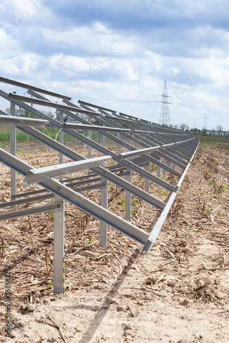 Metal structure for solar panels installation on an open field, part of a renewable energy project.