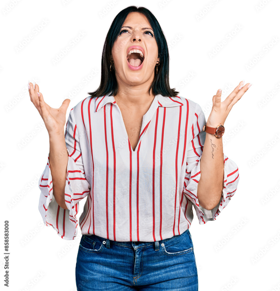 Φωτογραφία Young hispanic girl wearing casual clothes crazy and mad shouting and yelling with aggressive expression and arms raised