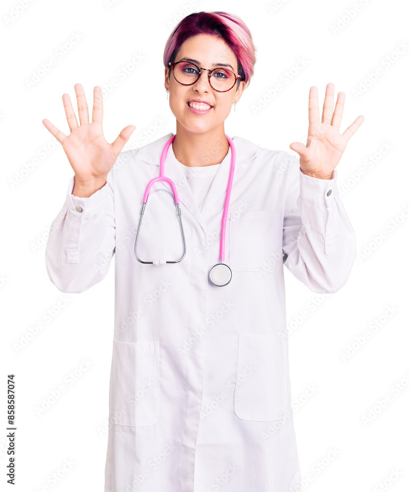 Φωτογραφία Young beautiful woman with pink hair wearing doctor uniform showing and pointing up with fingers number ten while smiling confident and happy