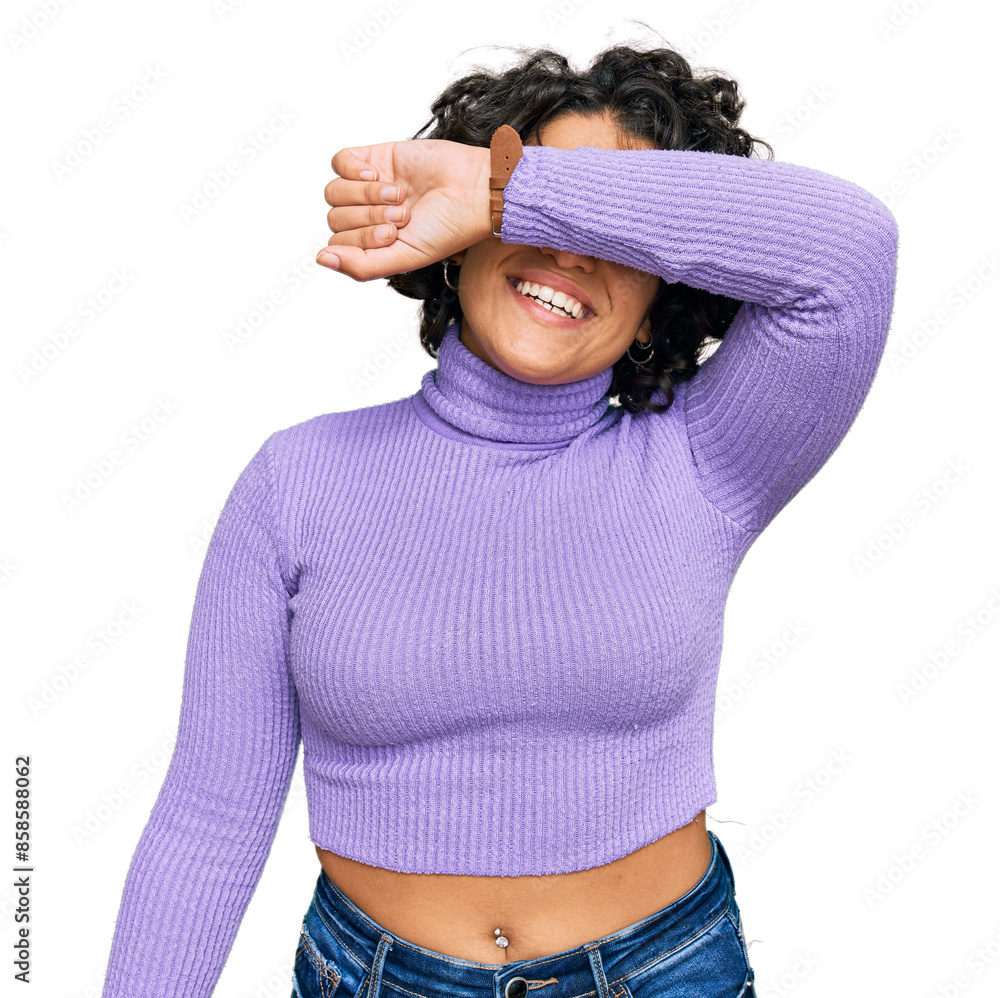 Φωτογραφία Young hispanic woman with curly hair wearing casual clothes covering eyes with arm smiling cheerful and funny