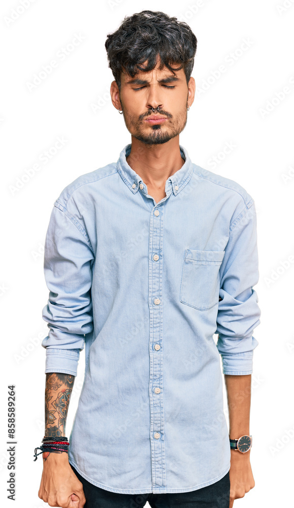 Fototapeta premium Young hispanic man wearing casual clothes looking at the camera blowing a kiss on air being lovely and sexy. love expression.