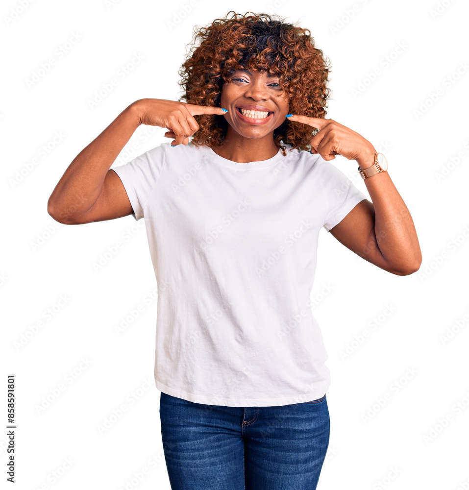 Young african american woman wearing casual white tshirt smiling cheerful showing and pointing with fingers teeth and mouth. dental health concept. Young african american woman wearing casual white tshirt smiling cheerful showing and pointing with fingers teeth and mouth. dental health concept.