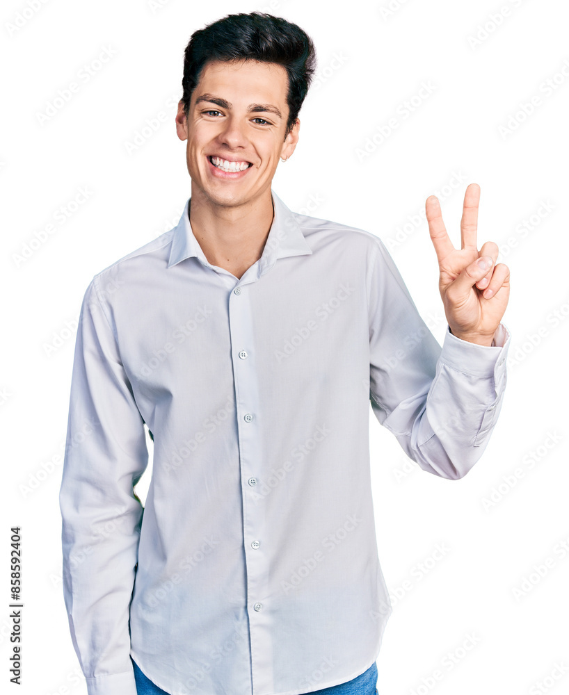 Young hispanic business man wearing business clothes smiling with happy face winking at the camera doing victory sign. number two. Young hispanic business man wearing business clothes smiling with happy face winking at the camera doing victory sign. number two.