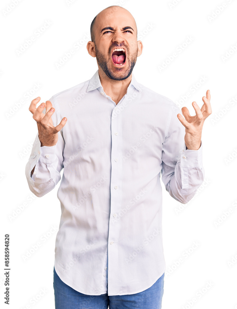 Young handsome man wearing elegant shirt crazy and mad shouting and yelling with aggressive expression and arms raised. frustration concept. Young handsome man wearing elegant shirt crazy and mad shouting and yelling with aggressive expression and arms raised. frustration concept.