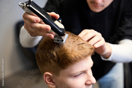 Skilled hairdresser working in modern hairdressing salon