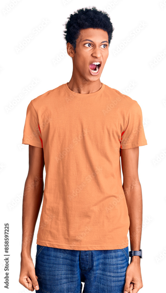 Young african american man wearing casual clothes angry and mad screaming frustrated and furious, shouting with anger. rage and aggressive concept. Young african american man wearing casual clothes angry and mad screaming frustrated and furious, shouting with anger. rage and aggressive concept.