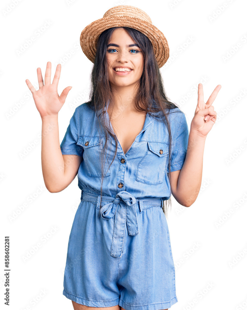 Brunette teenager girl wearing summer hat showing and pointing up with fingers number seven while smiling confident and happy. Brunette teenager girl wearing summer hat showing and pointing up with fingers number seven while smiling confident and happy.